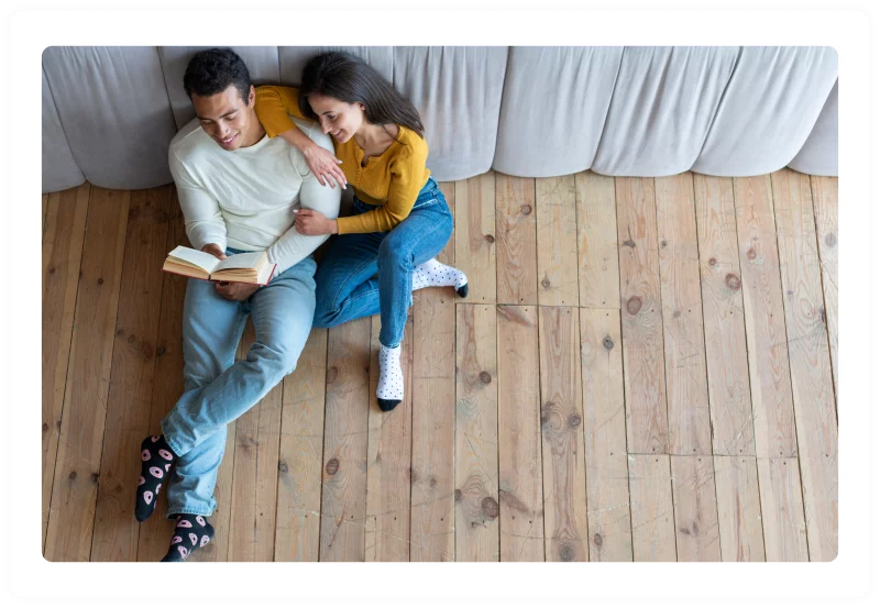 Couple sitting on hardwood alternative flooring